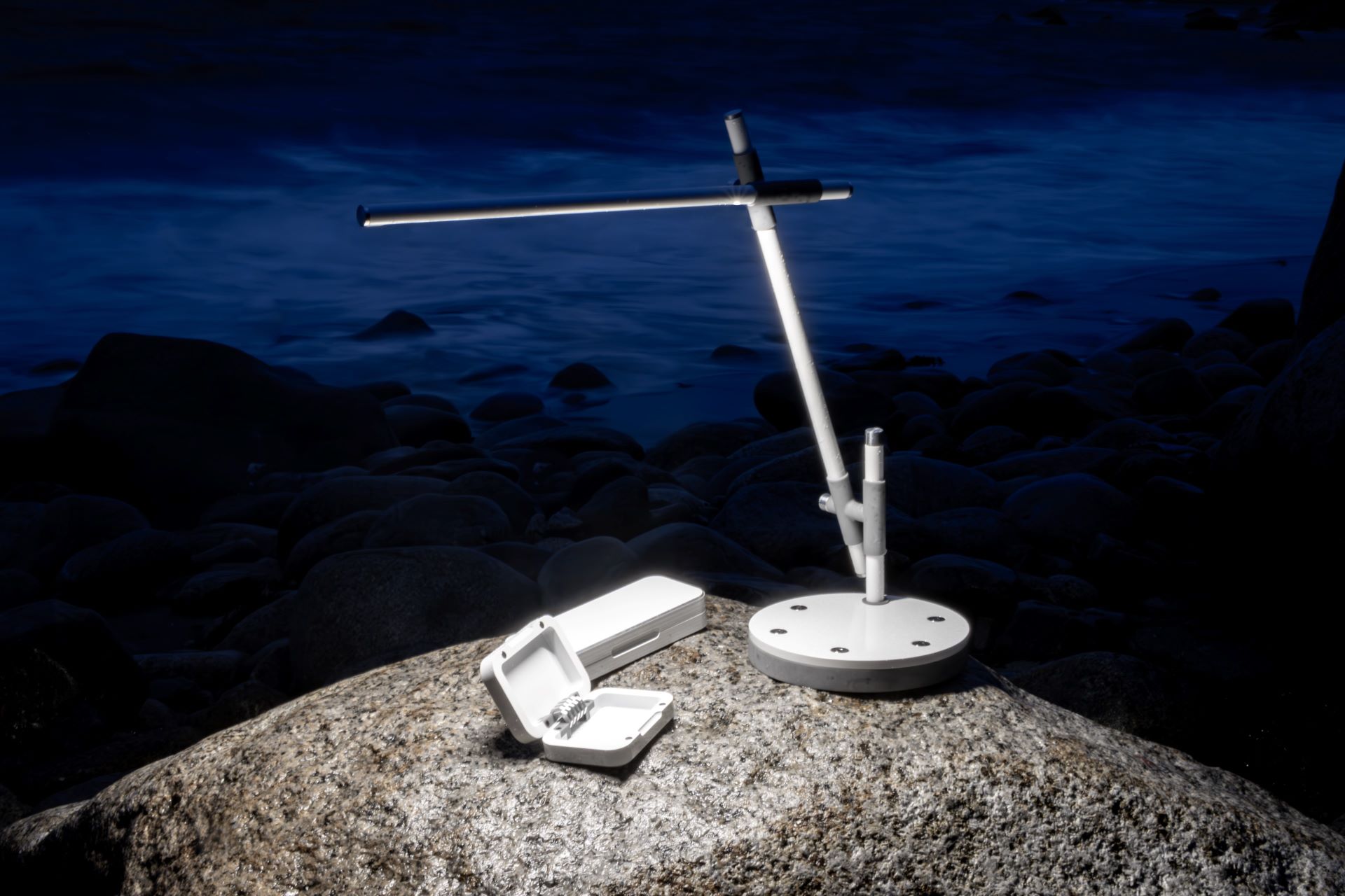 Mare Desk Lamp on a rock next to the ocean at night